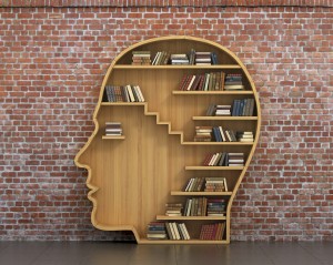 Concept of training. Wooden bookshelf full of books in form of m